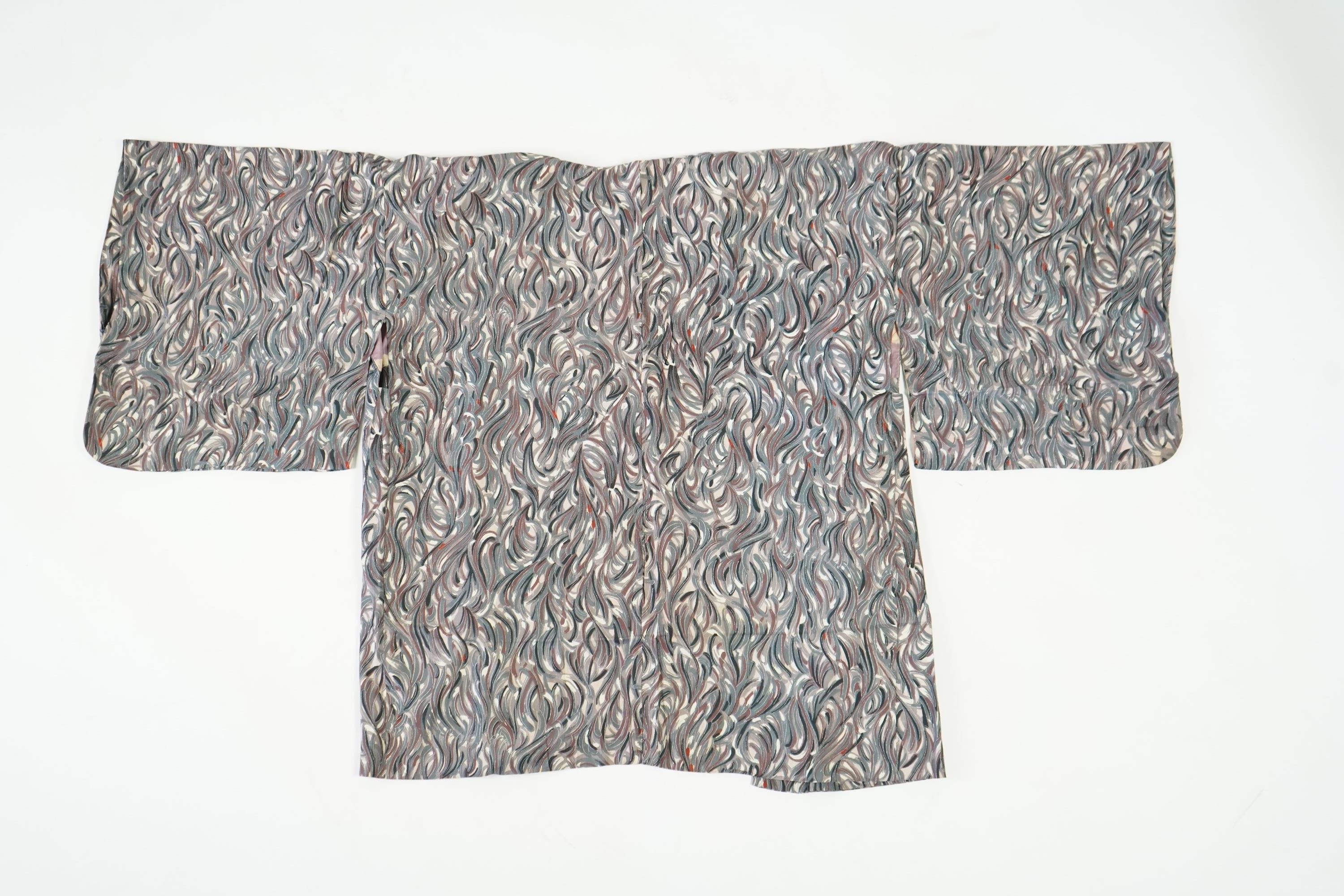 Three Japanese mid 20th century ‘Haori’ printed silk jackets. One red with brightly coloured lining and rust brown floral silk lining. All with large kimono sleeves. Grey patterned Haori, 79cm long., Condition - good